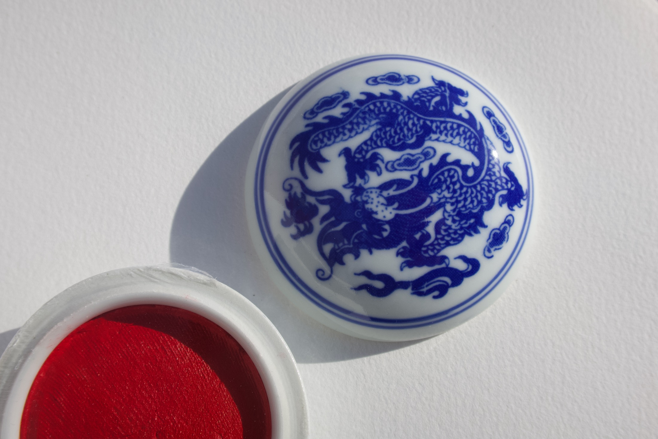Chinese White Chinese porcelain dragon inspired by traditional Chinese calligraphy seals.